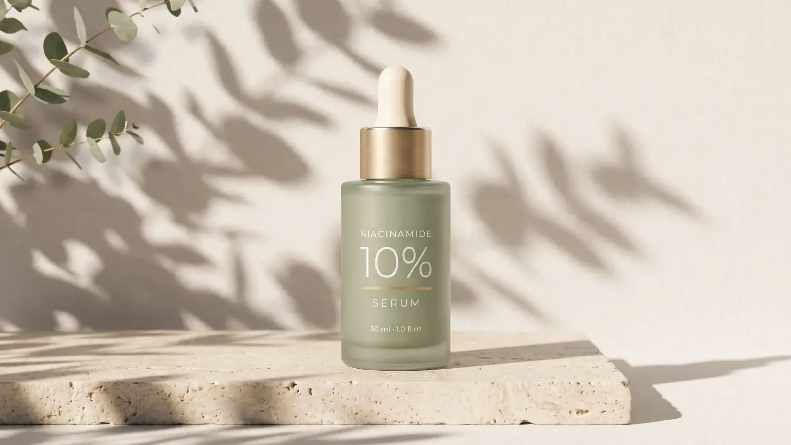 The same serum on a travertine slab under leaf shadows, composed for a 16:9 site banner