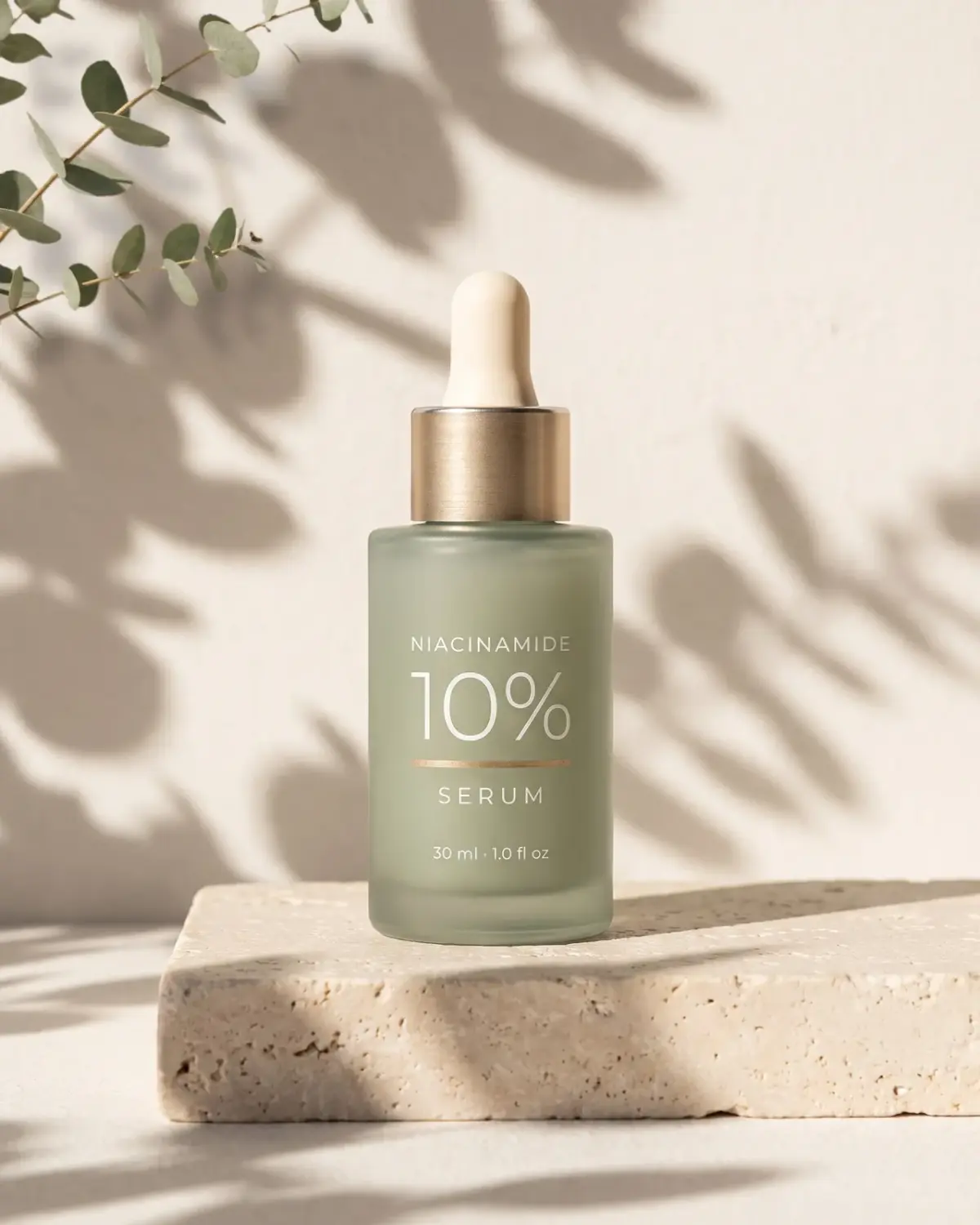 The same serum on a travertine slab under leaf shadows, composed for a 4:5 feed post